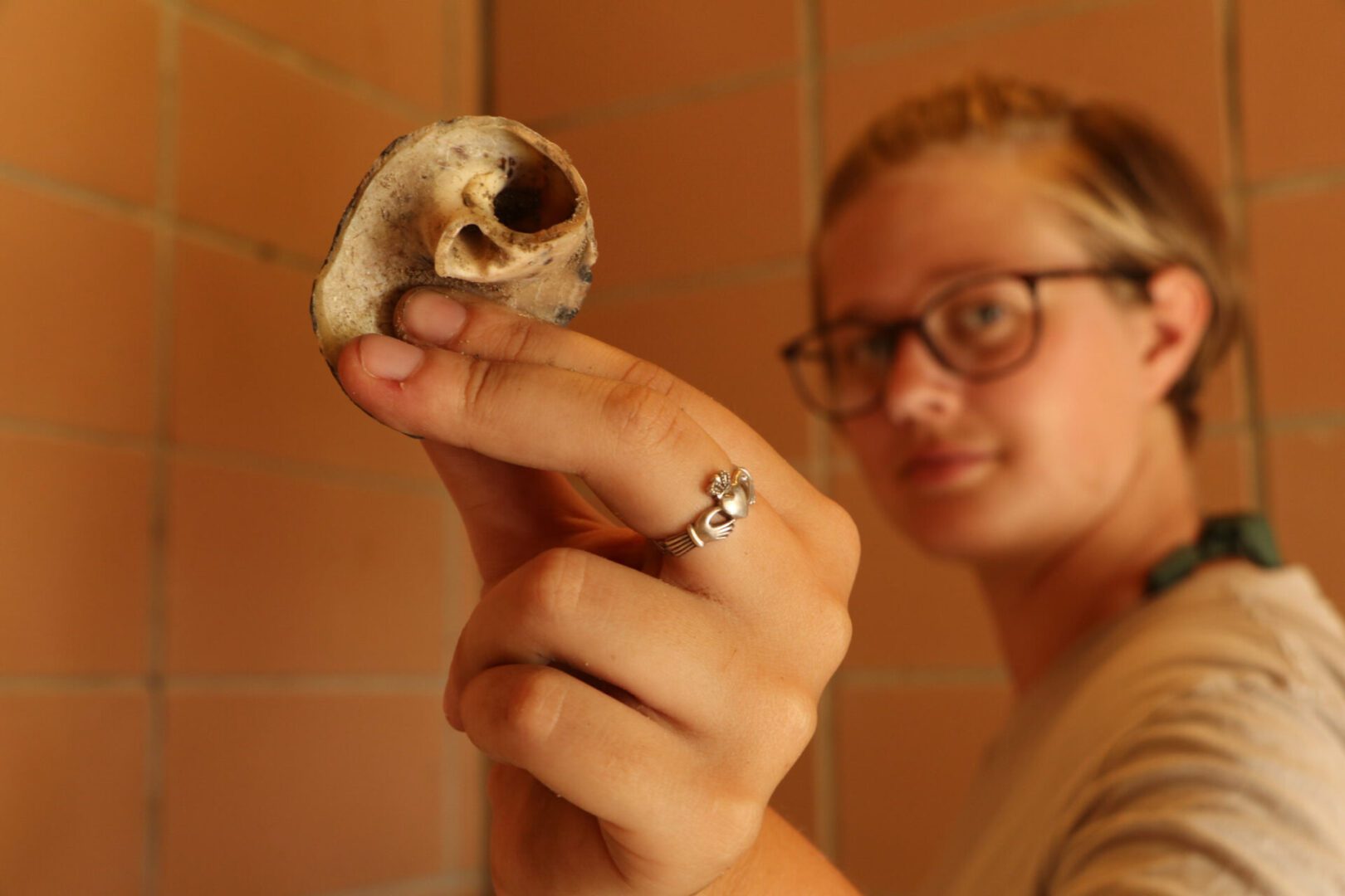 A woman holding an artifact