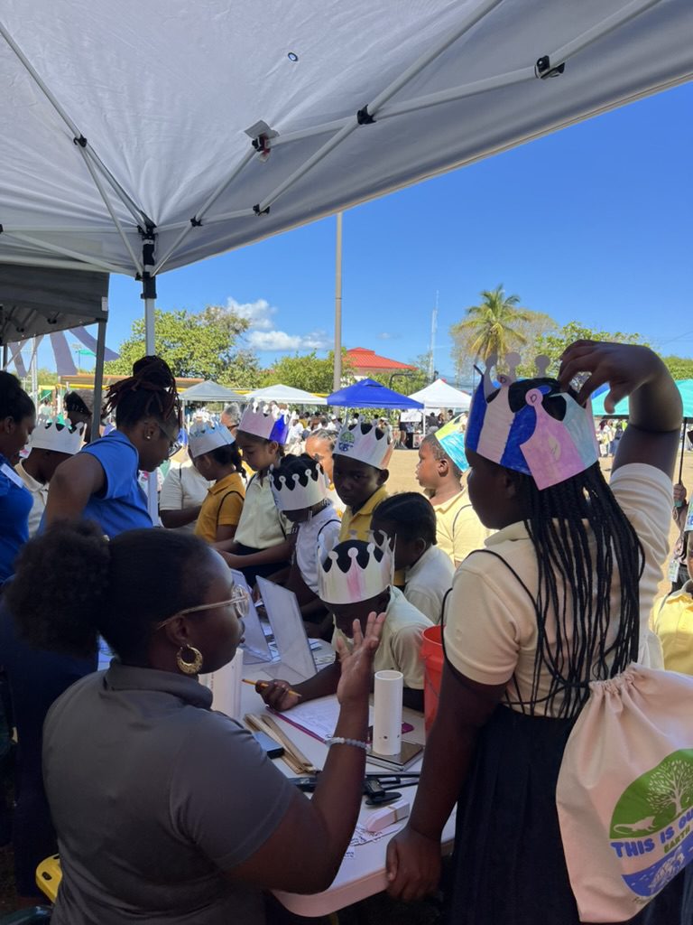 Children wearing paper crowns at outdoor booth