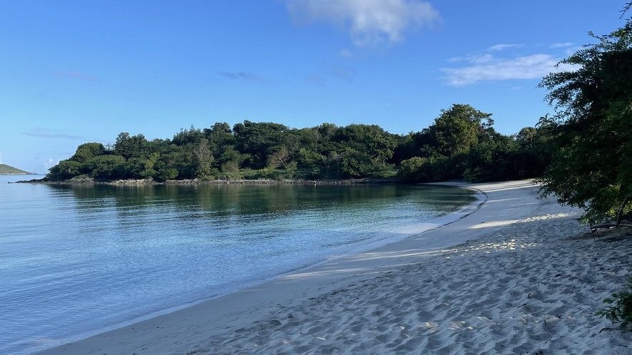 Secluded sandy cove with calm turquoise water